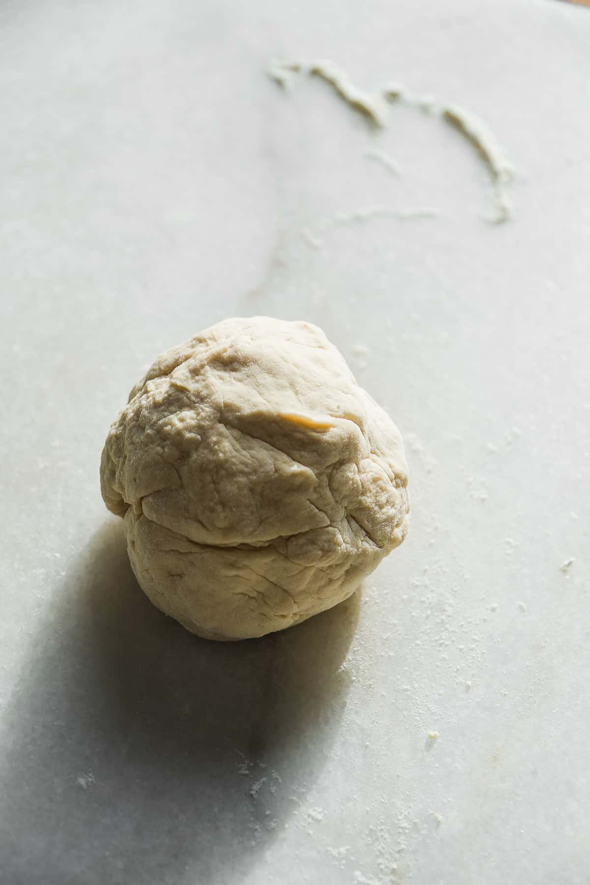 Ball of dough on a marble surface.