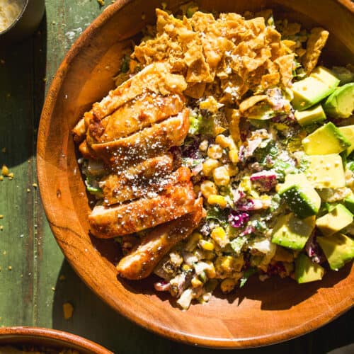 Elote salad with sliced chicken and avocados.