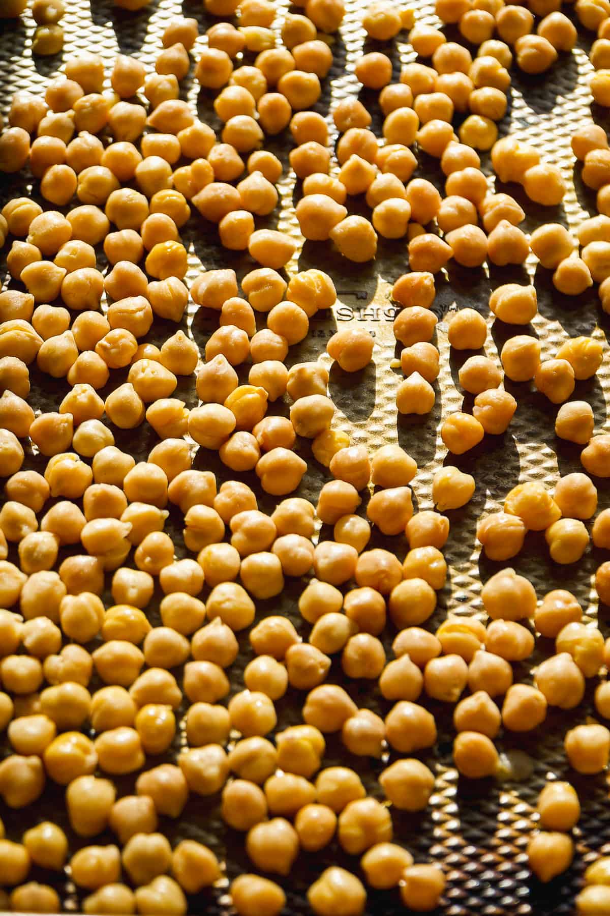 Chickpeas on a baking sheet about to be roasted.