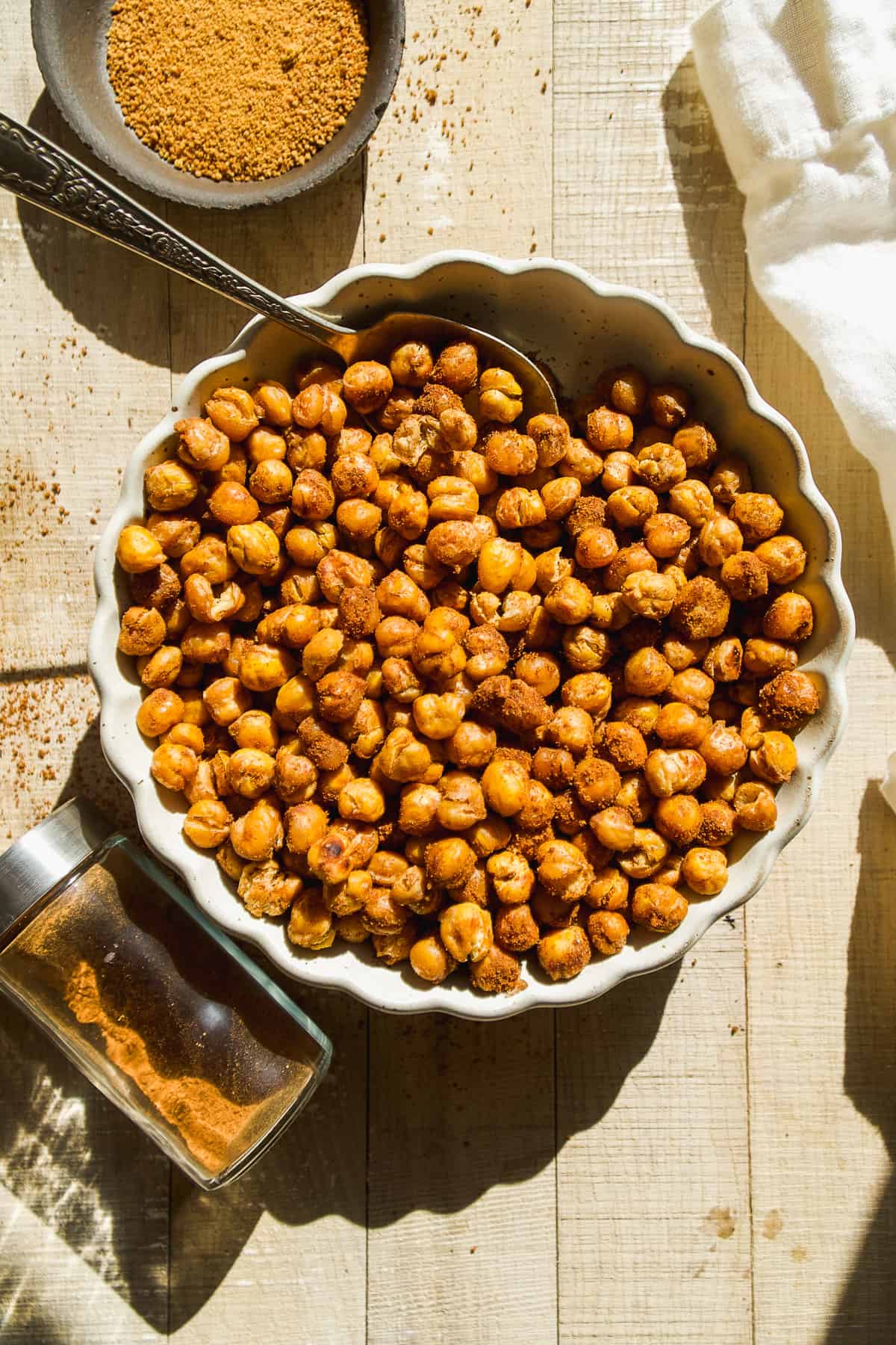 Overhead view of chickpeas in a bowl roasted with cinnamon sugar.