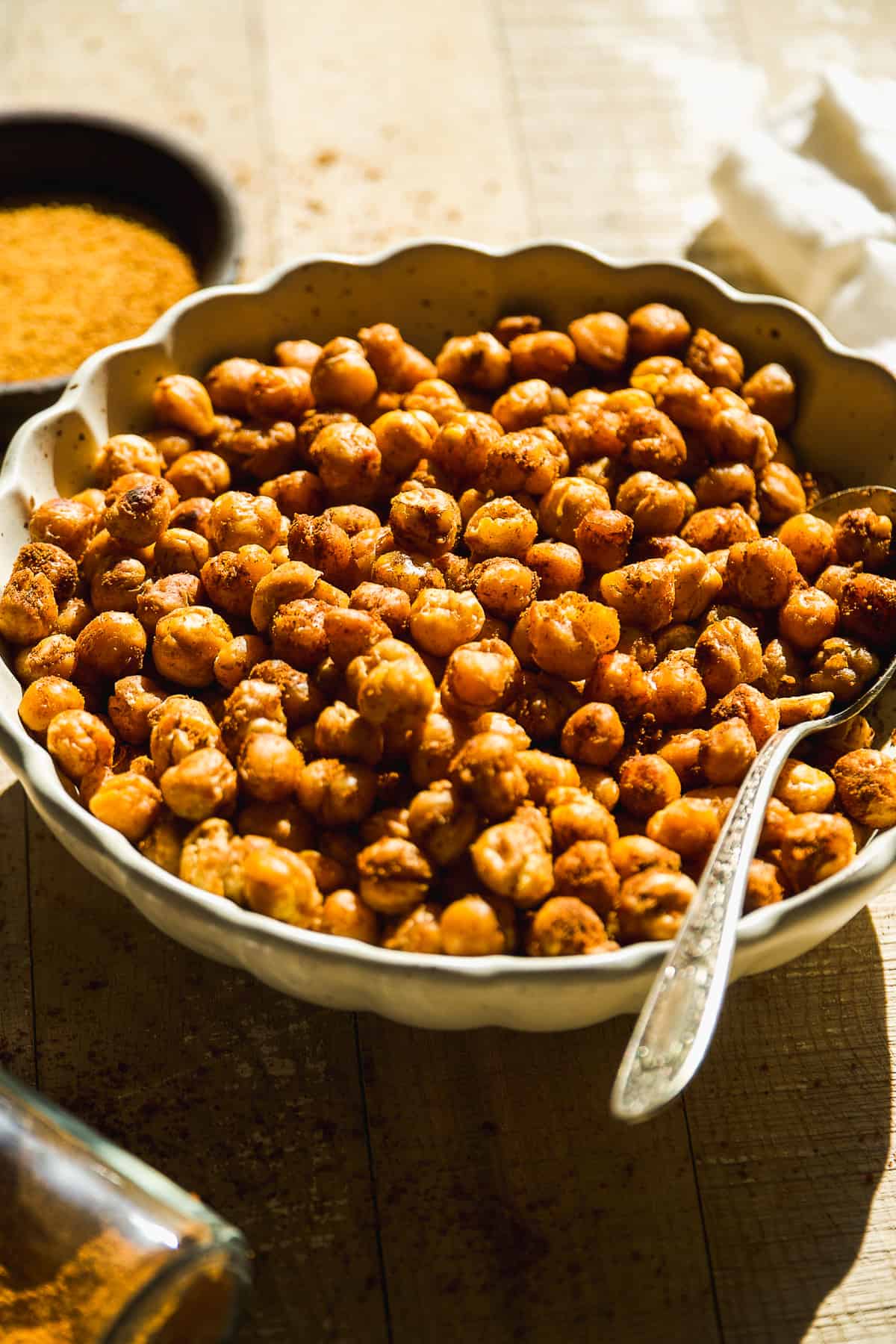 Cinnamon roasted chickpeas in a bowl with a spoon.