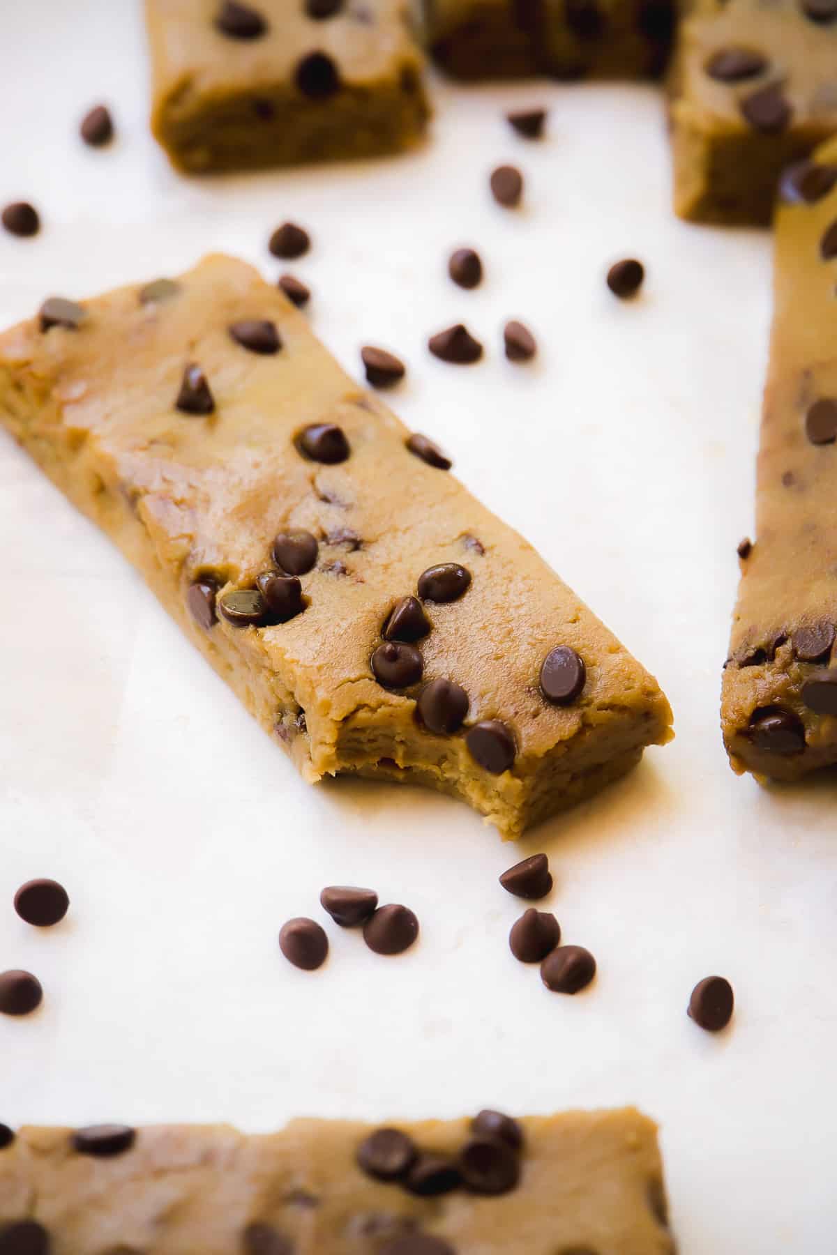 Chickpea cookie dough protein bar on a white surface.