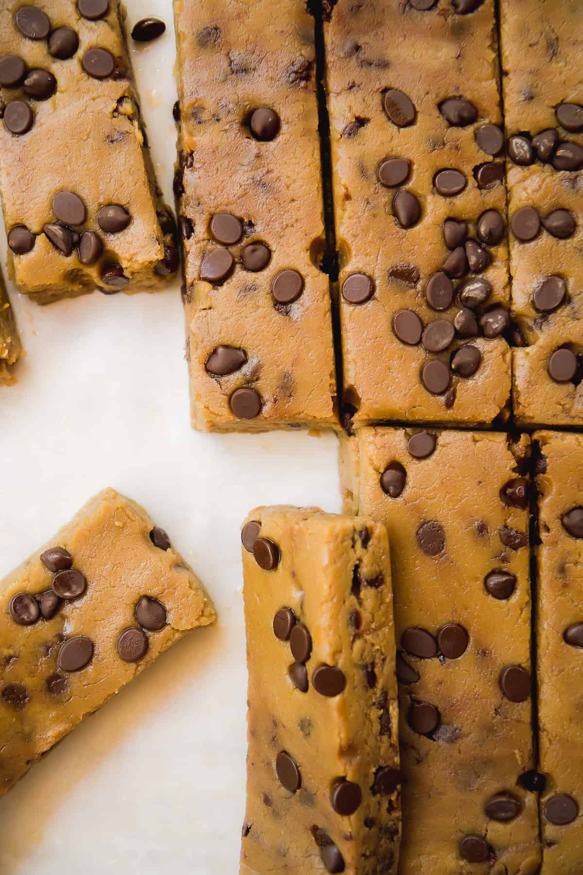 Chickpea cookie dough protein bars on a piece of parchment paper.