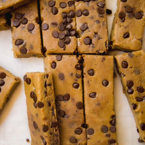 Overhead view of chickpea cookie dough protein bars cut into rectangles.
