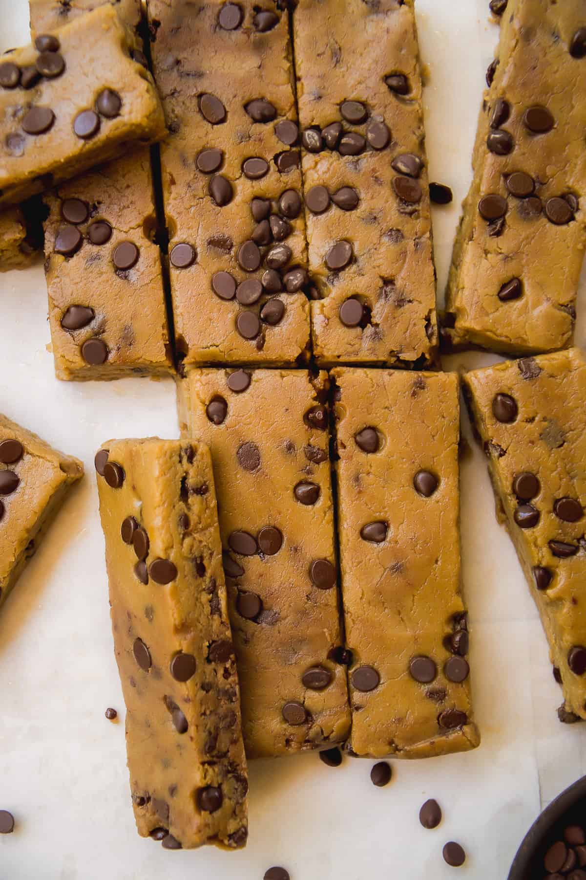 Overhead view of chickpea cookie dough protein bars cut into rectangles.