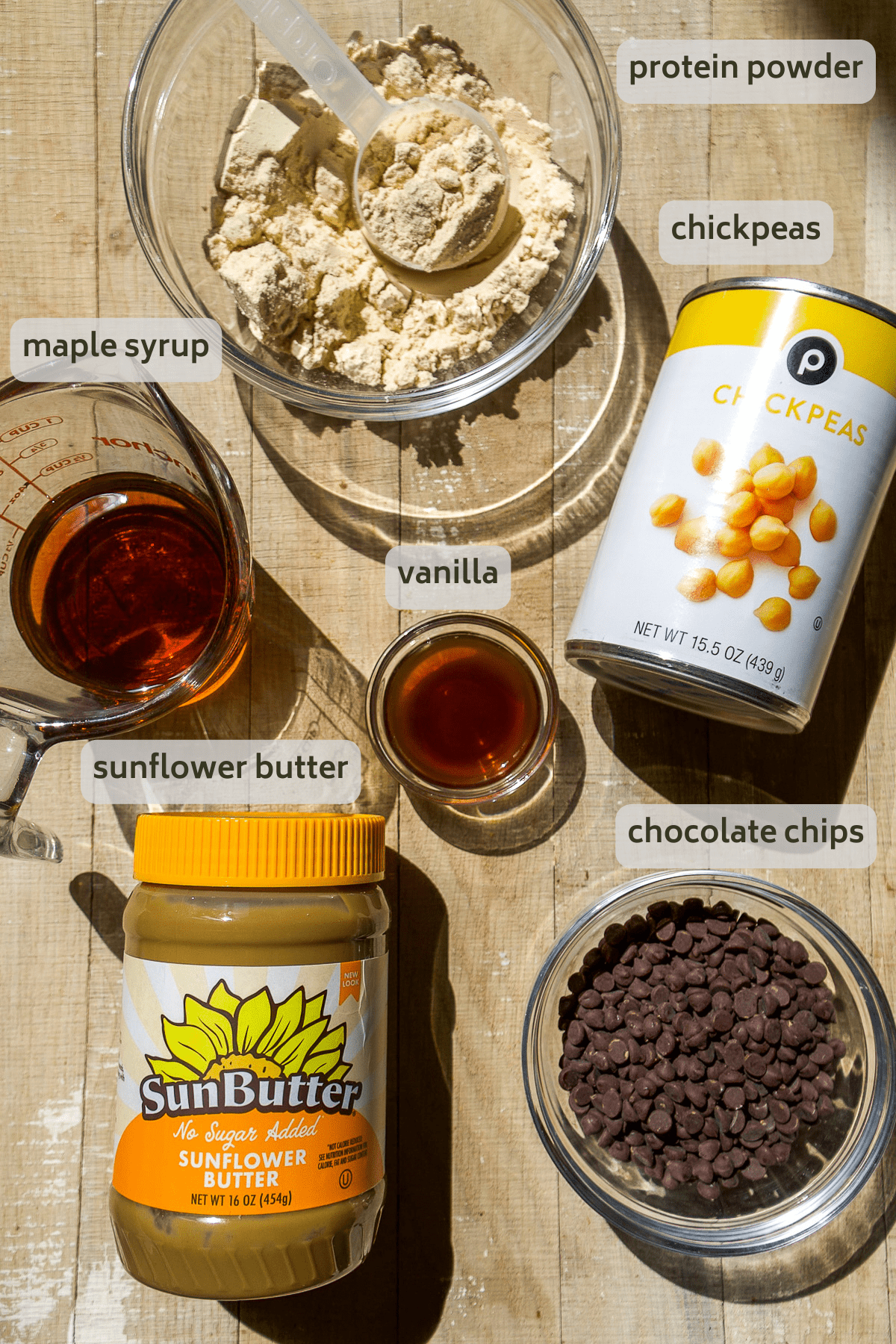 Chickpea cookie dough protein bar ingredients on a wooden surface.