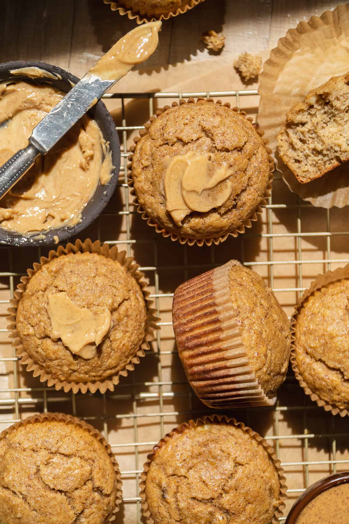 Banana almond flour muffins scattered on a cooling rack.