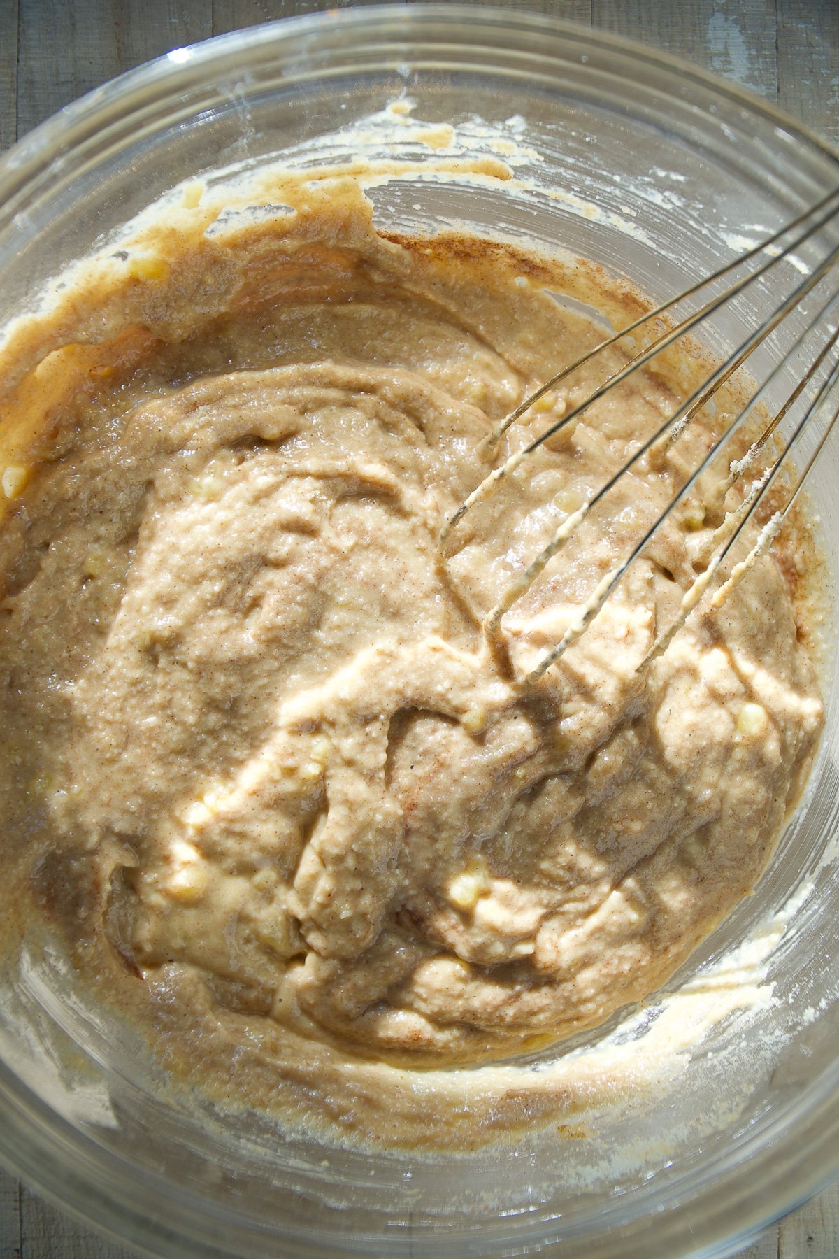 Banana almond flour muffin batter in a glass bowl.