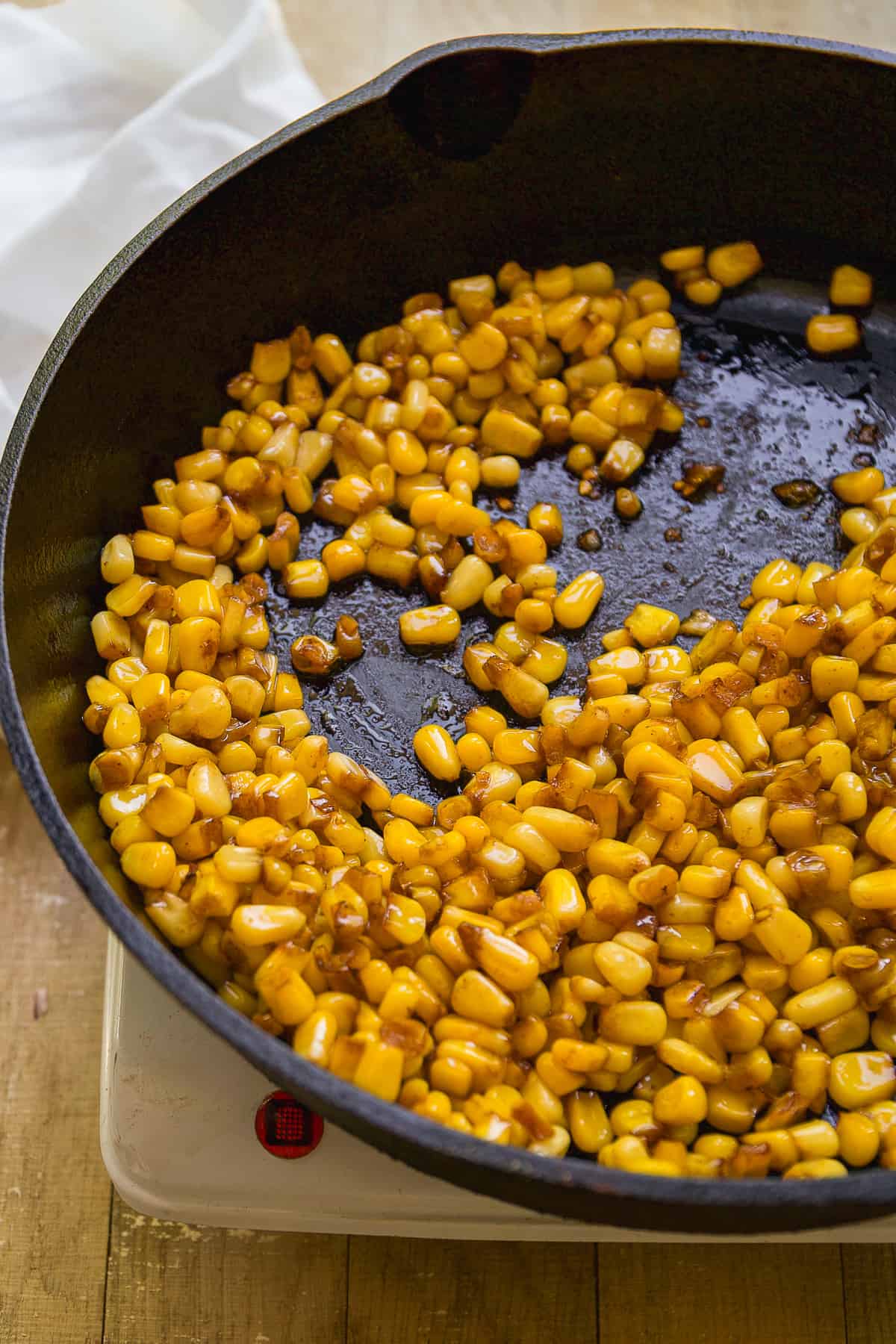 Corn roasting in a cast iron skillet.