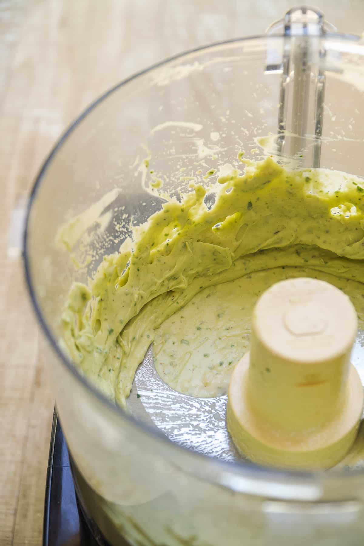 Cilantro avocado sauce mixed in a food processor.