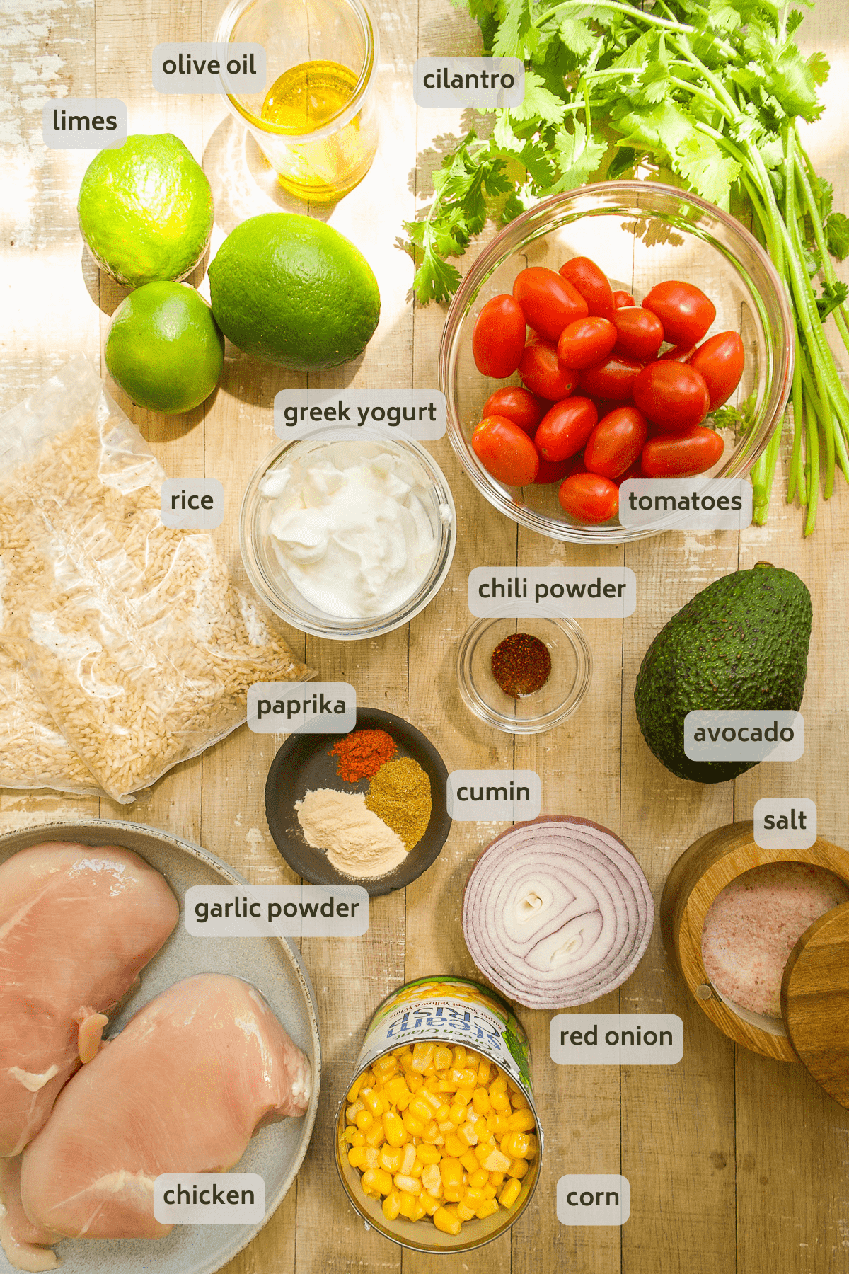 Chicken taco ingredients with labels on a wooden surface.