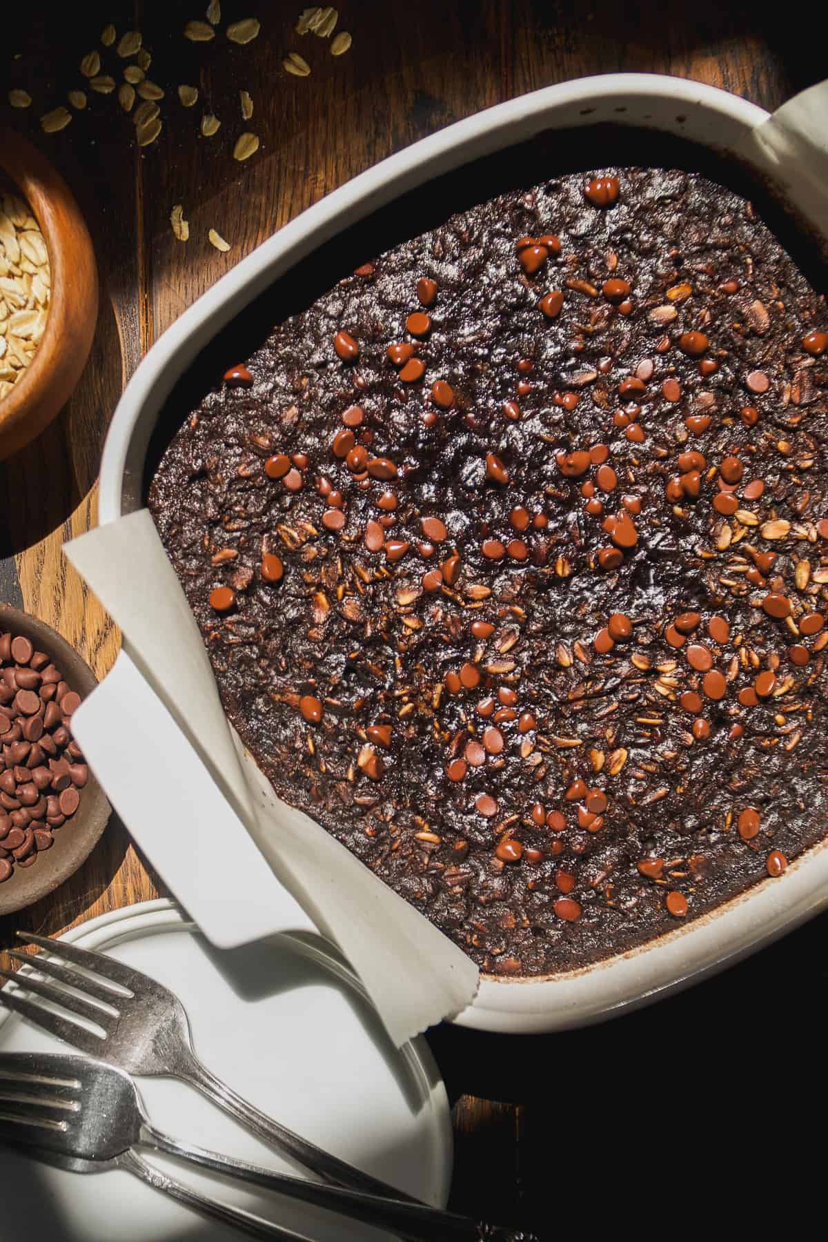 Baked chocolate oats in a white dish.