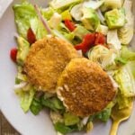 Goat cheese salad with two fried goat cheese patties on top.