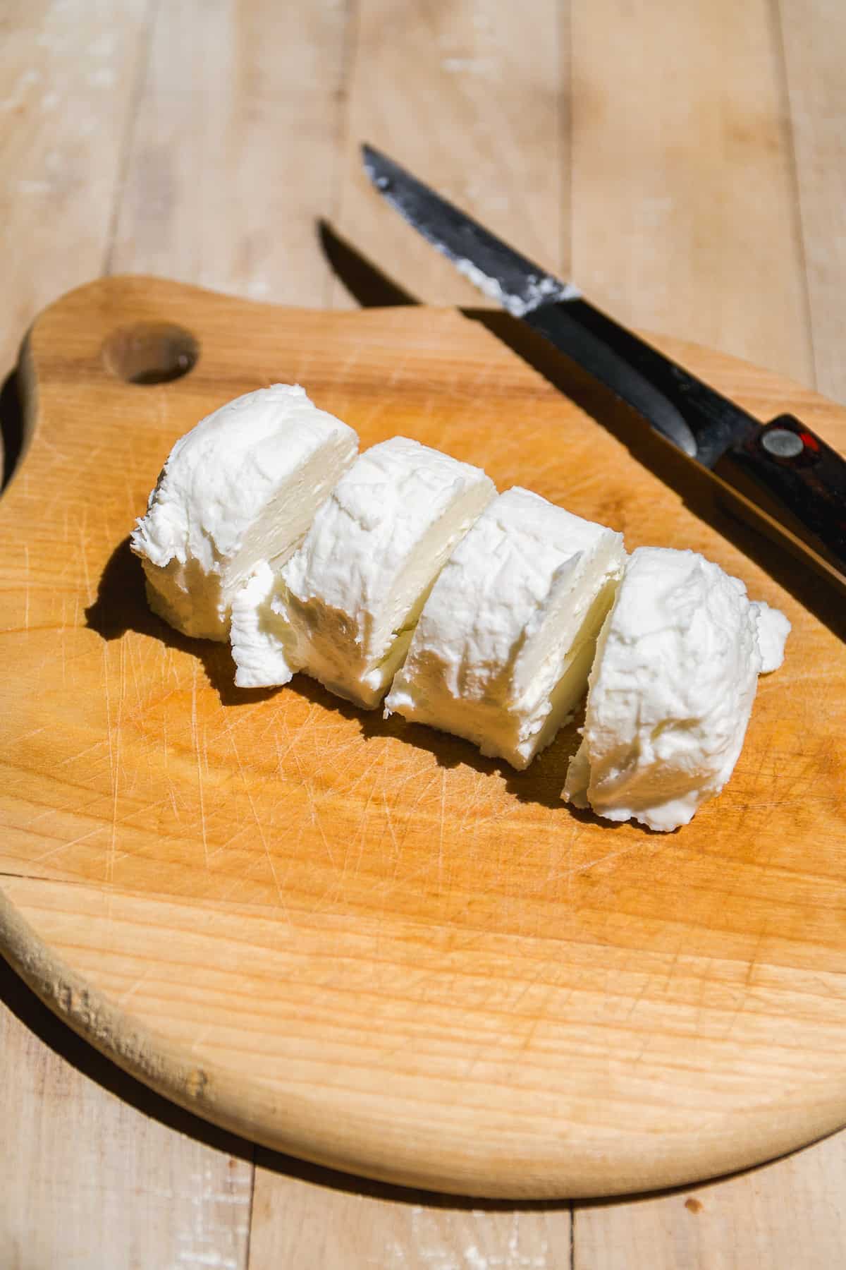 Goat cheese log cut into four pieces.