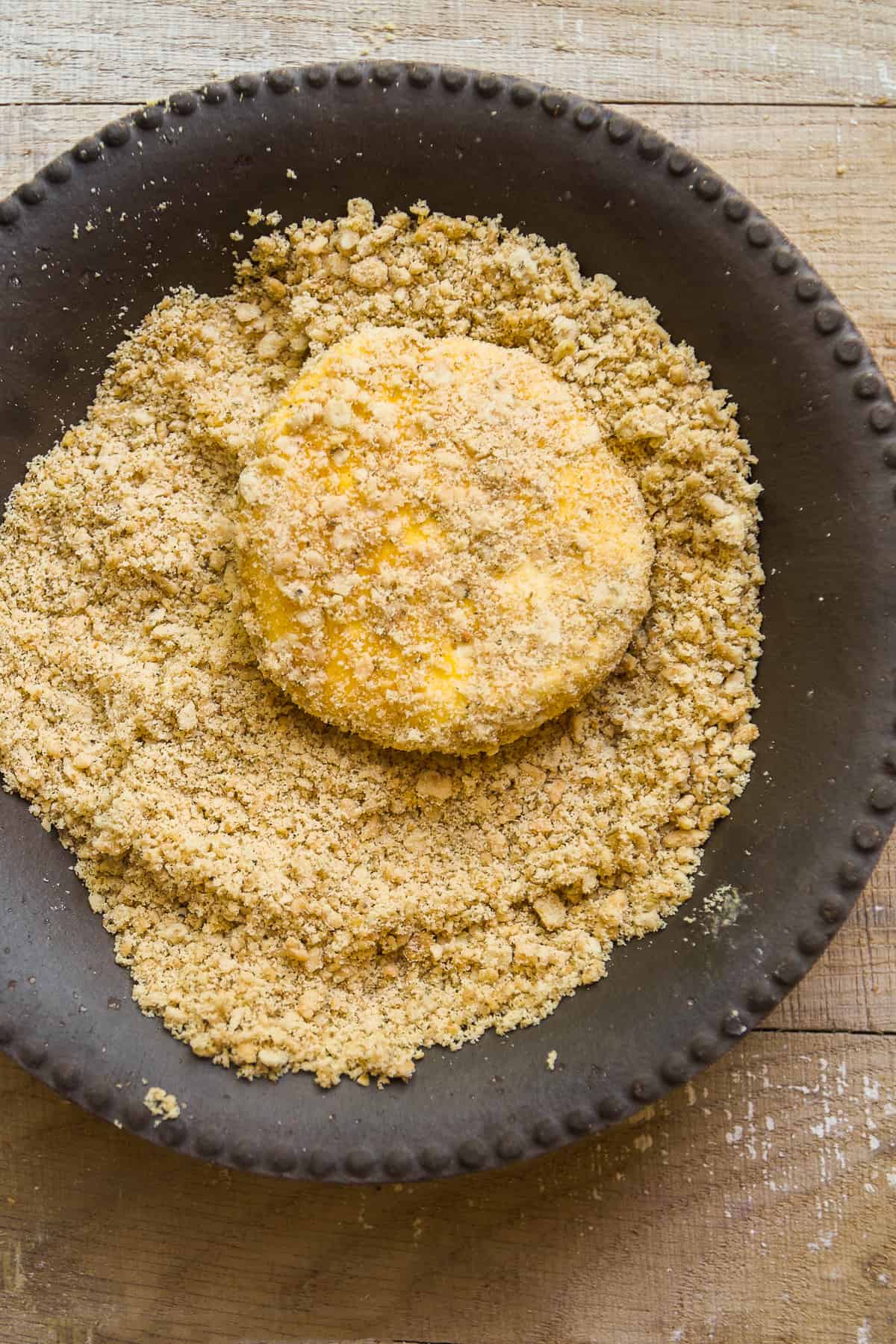 Goat cheese patty covered in crushed crackers.