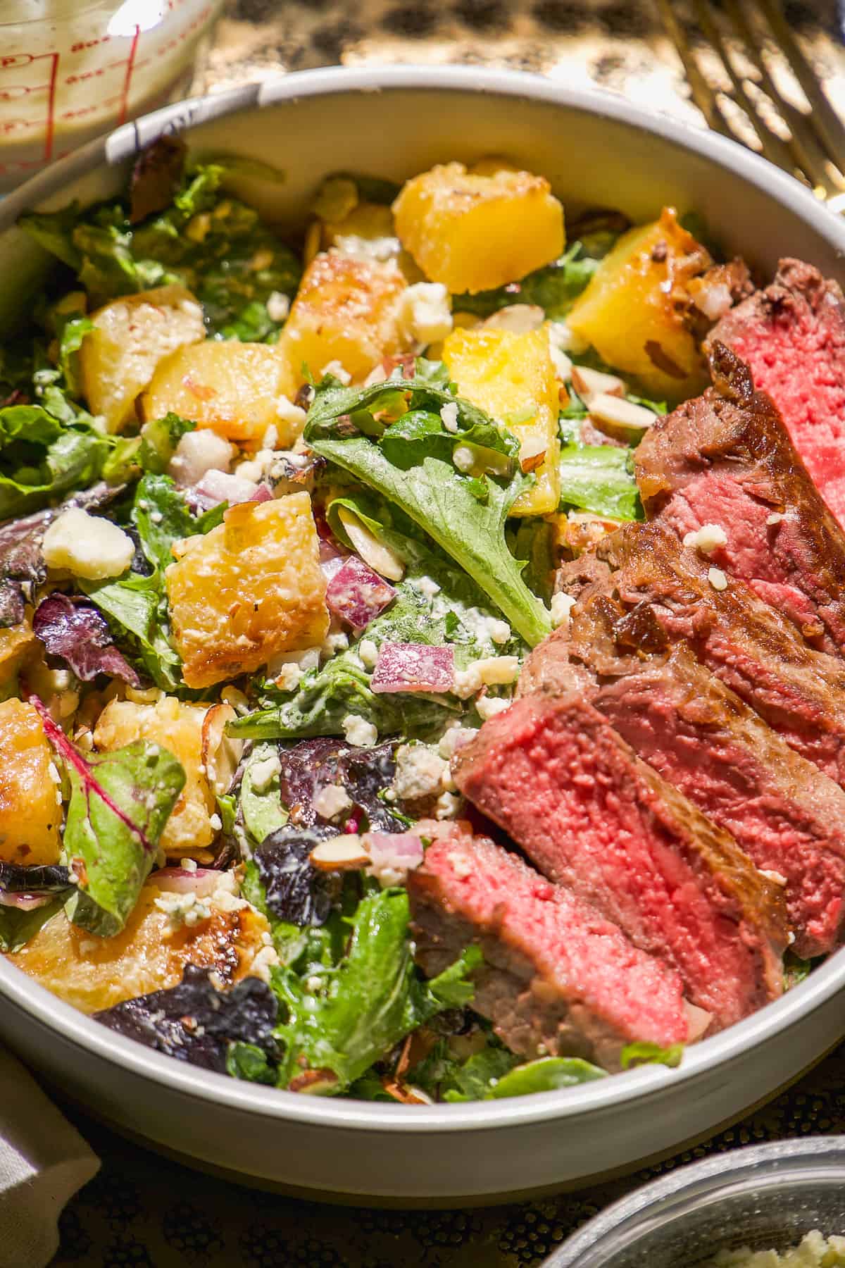 Steak salad with gorgonzola dressing on a plate.