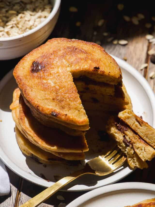 Chocolate oat flour pancakes with a sliver taken out of it.