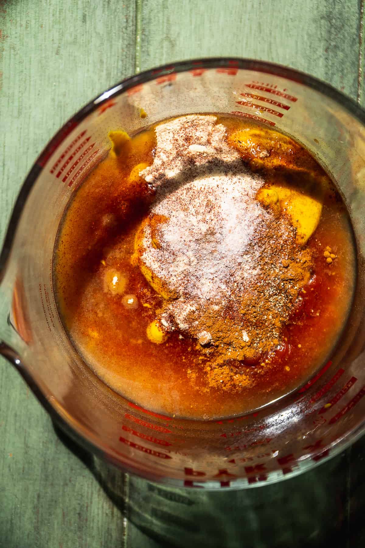 Overhead view of a glass bowl with bbq sauce.