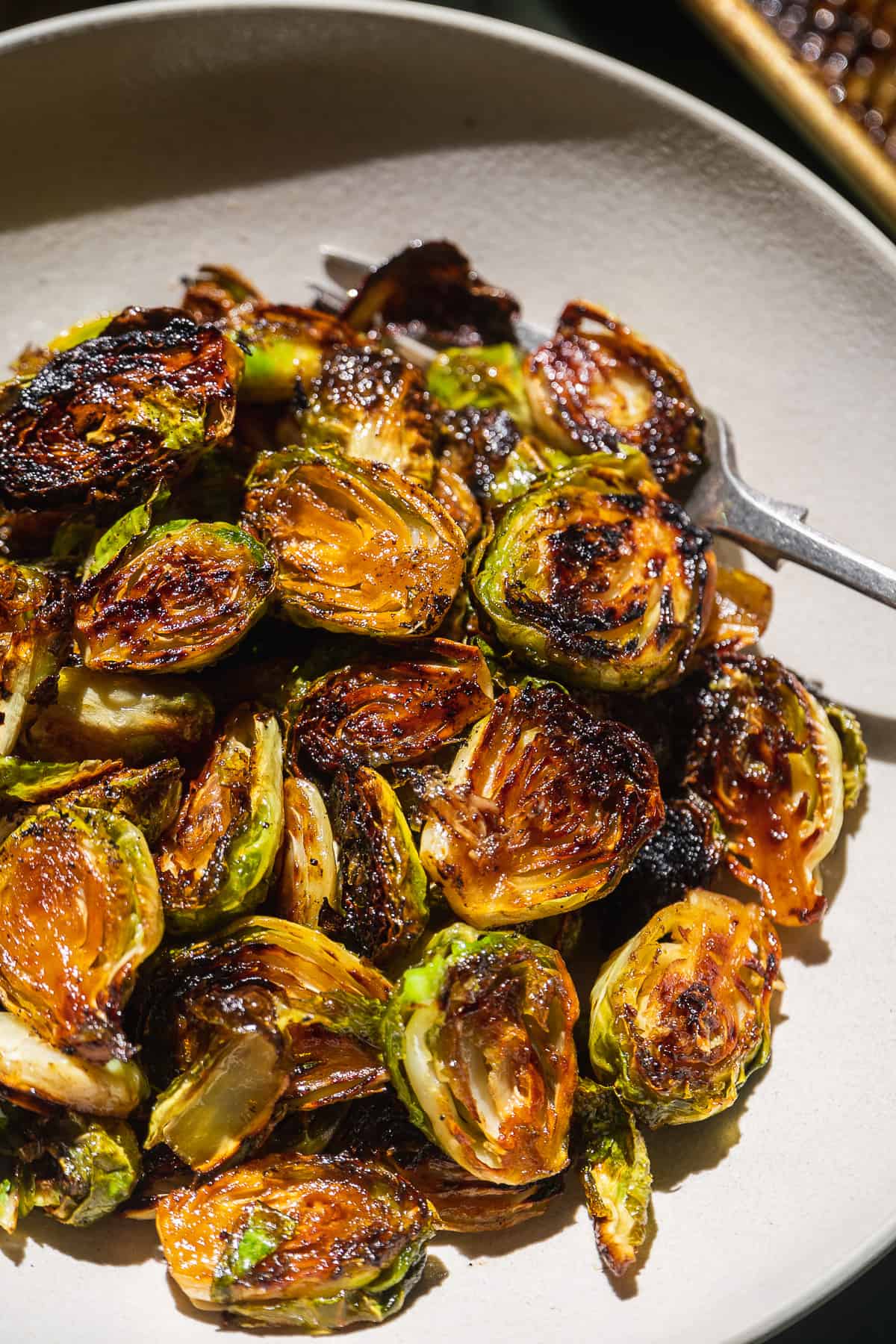 Caramelized brussel sprouts in a gray bowl.