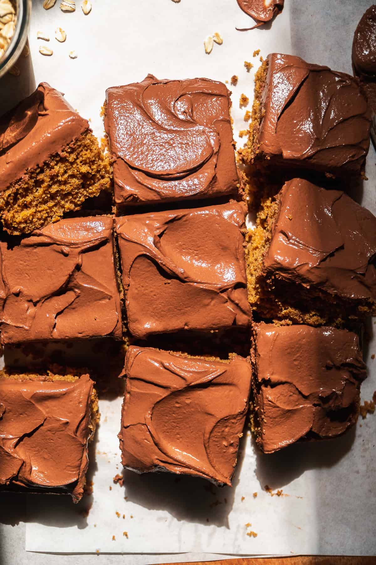 Oat flour cake with icing cut into squares.