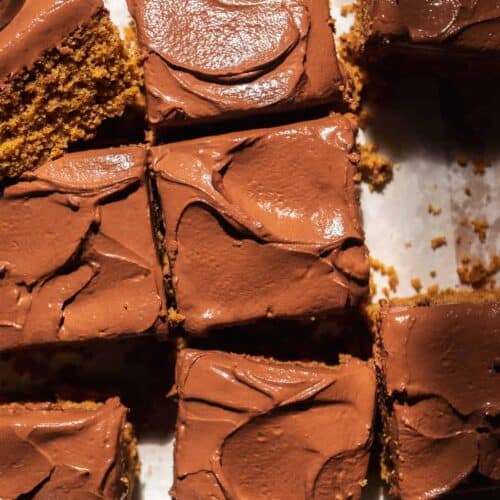 Chocolate oat flour cake cut into slices on parchment paper.