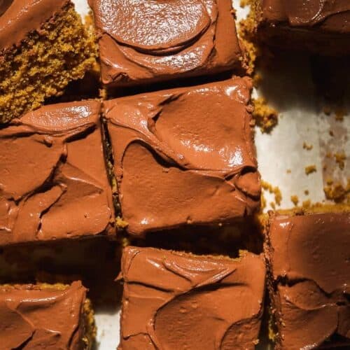 Oat flour cake with chocolate yogurt icing cut into squares.