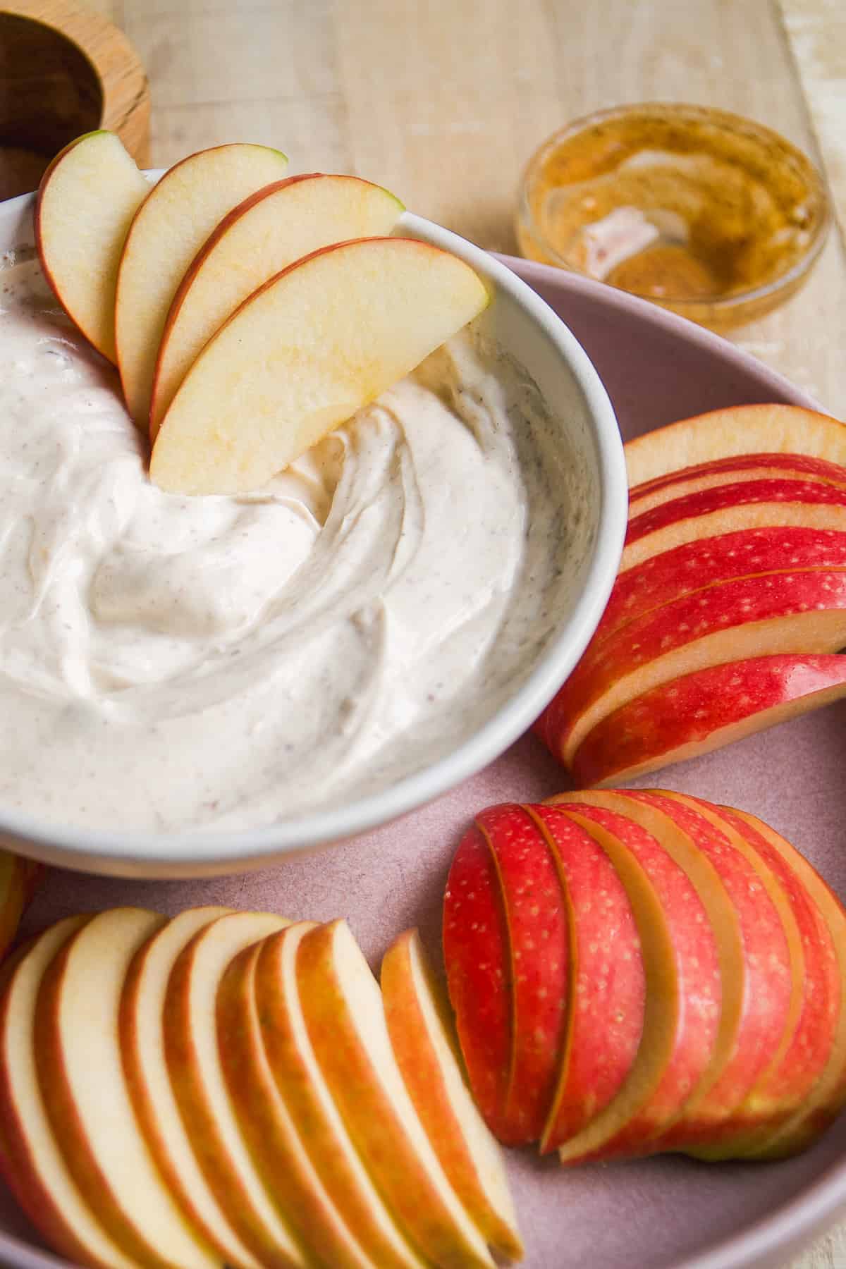 Yogurt fruit dip with apple slices on the side.