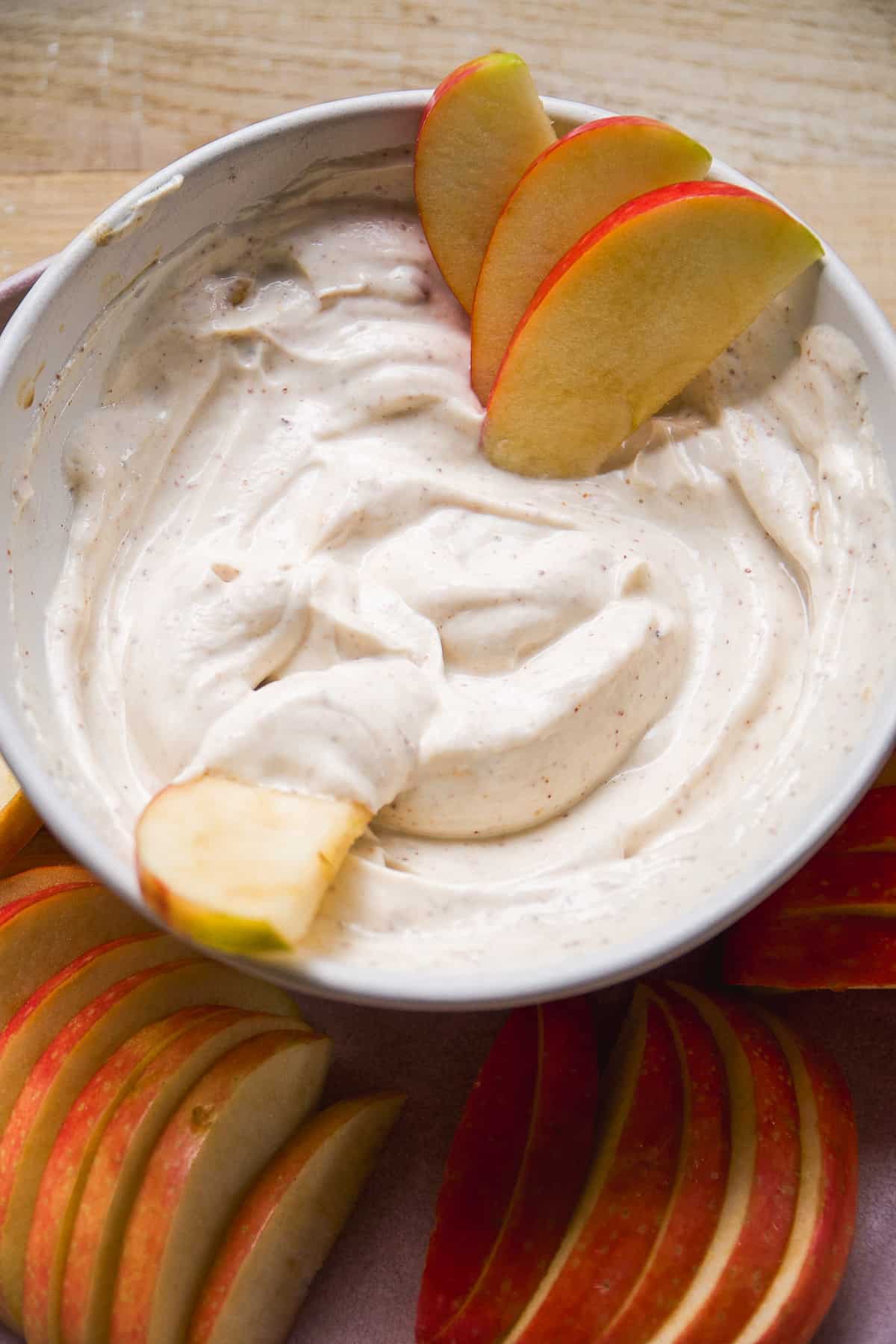 Almond butter yogurt fruit dip with apple slices on the side.