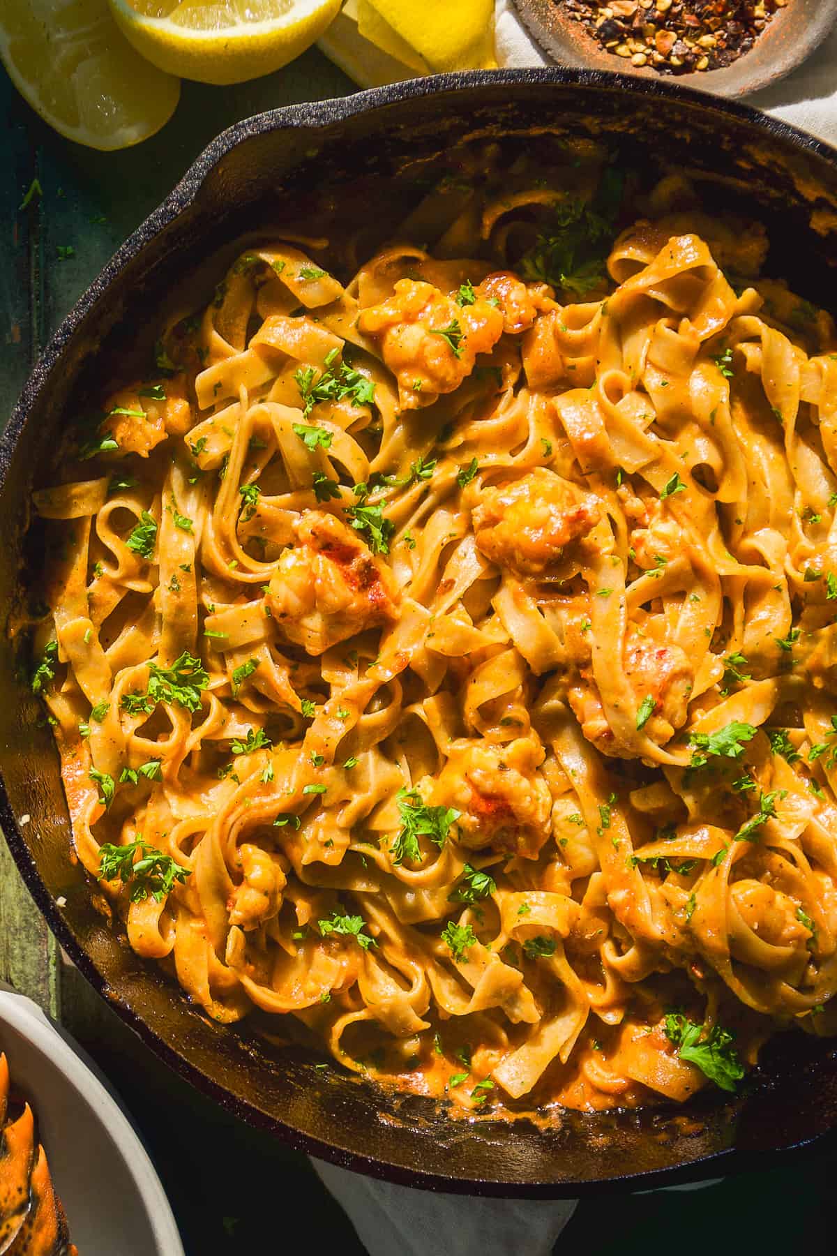 Overhead view of a skillet with lobster pasta.