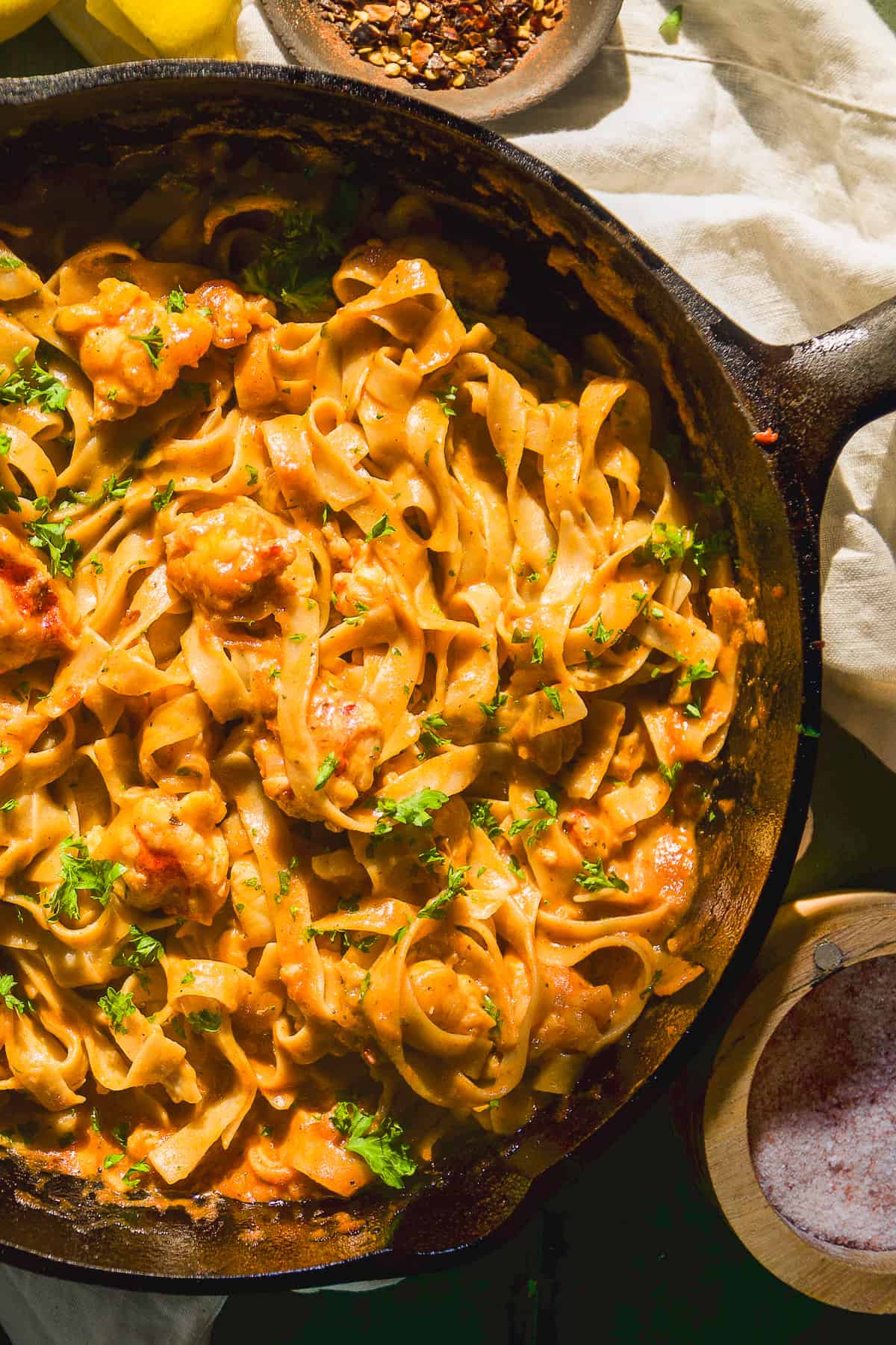 Lobster pasta with parsley in a cast iron skillet.