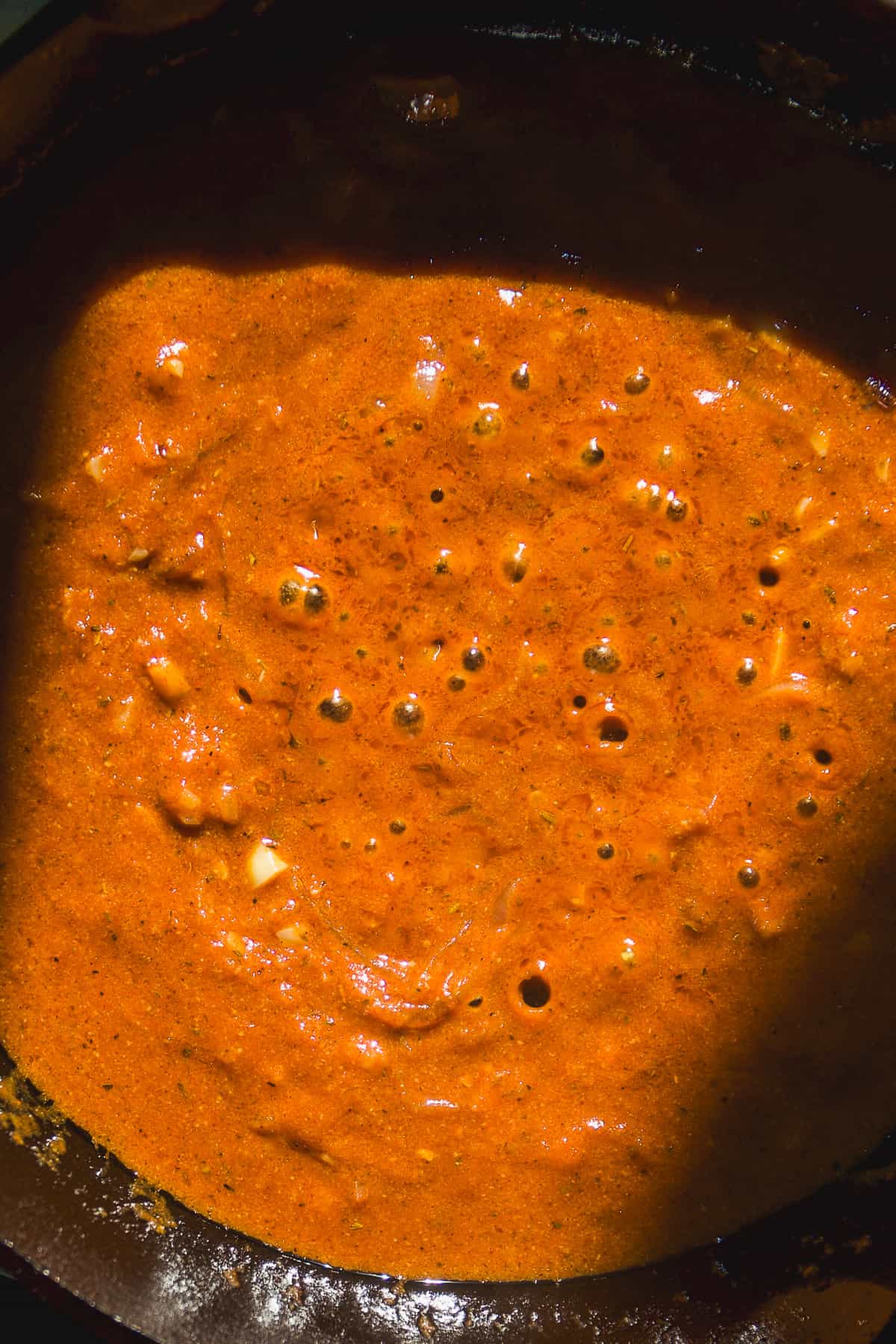 Cajun pasta sauce simmering in a skillet.