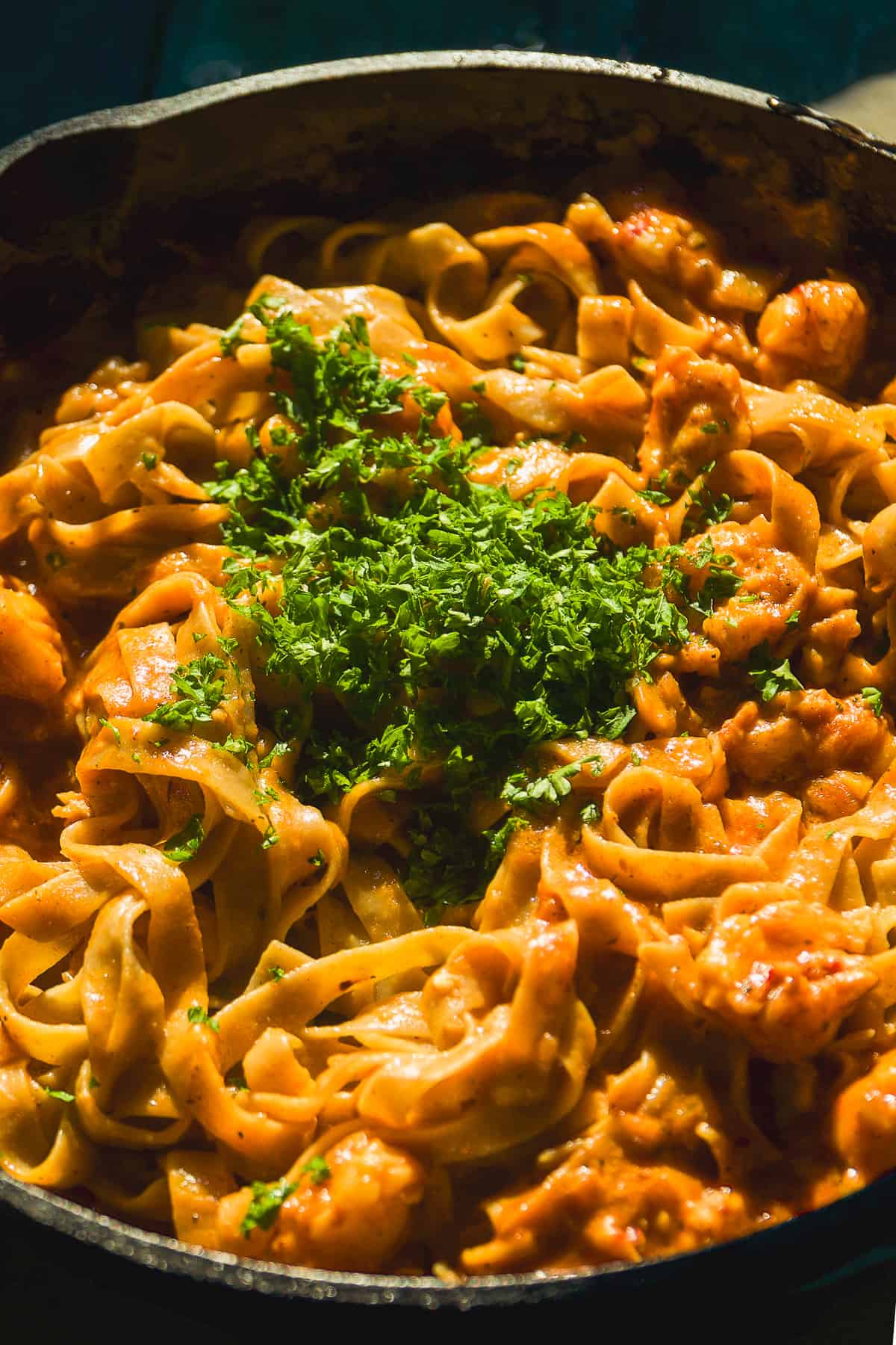 Parley finely chopped on top of a pile of cajun lobster pasta.