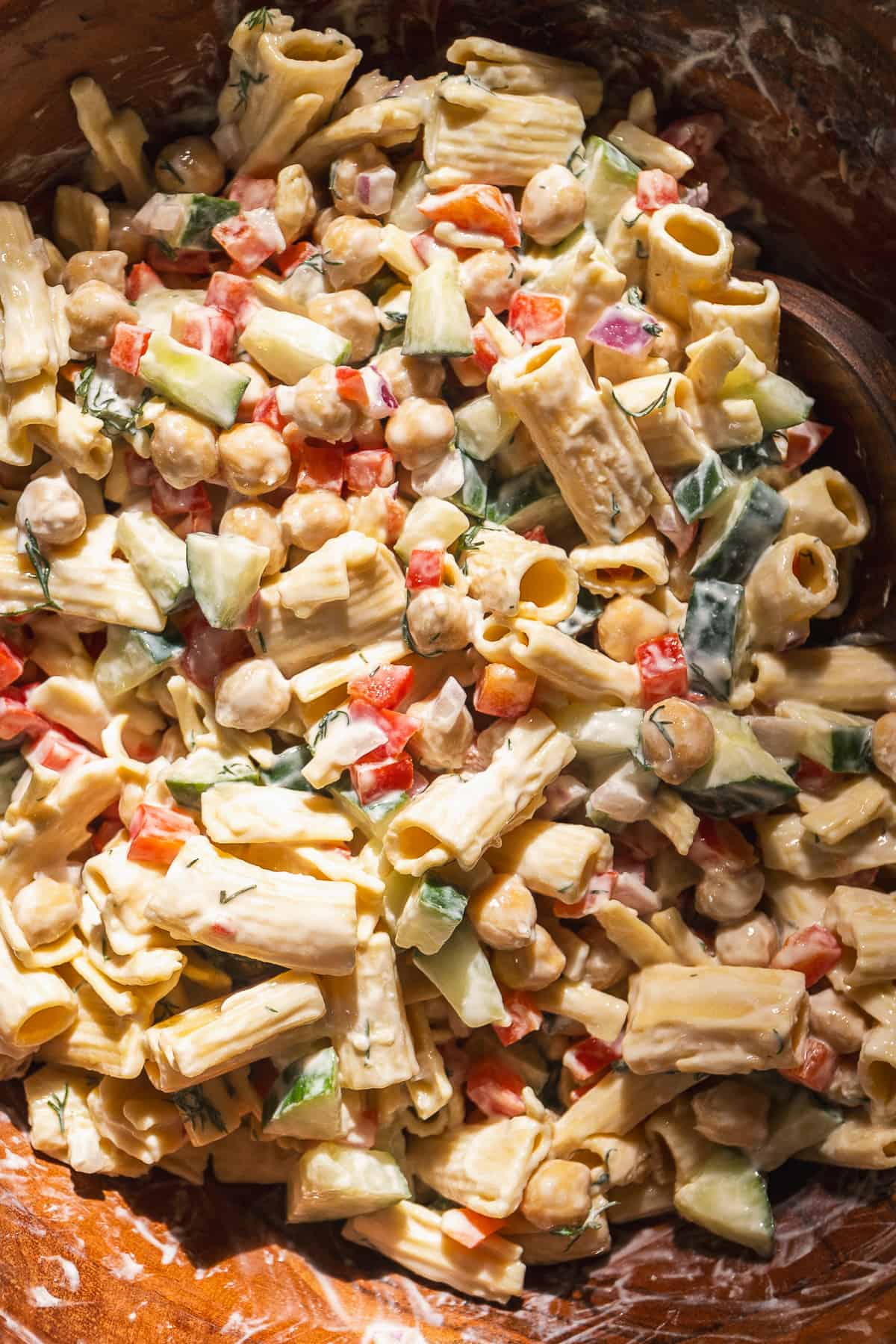 Chickpea pasta salad in a large wooden bowl.