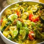 Basil pesto grilled vegetable salad in a circular dish.