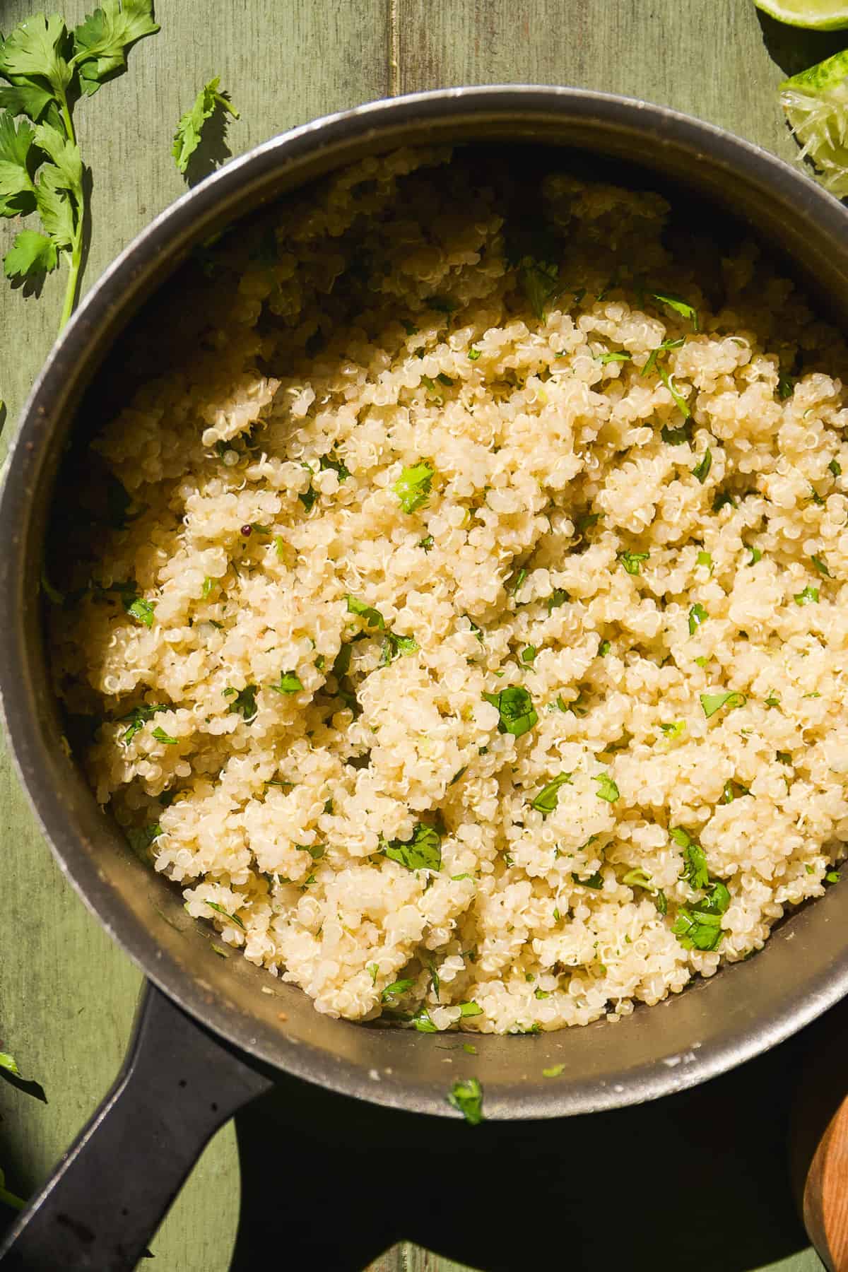 Cilantro lime quinoa in a pot on a green surface.