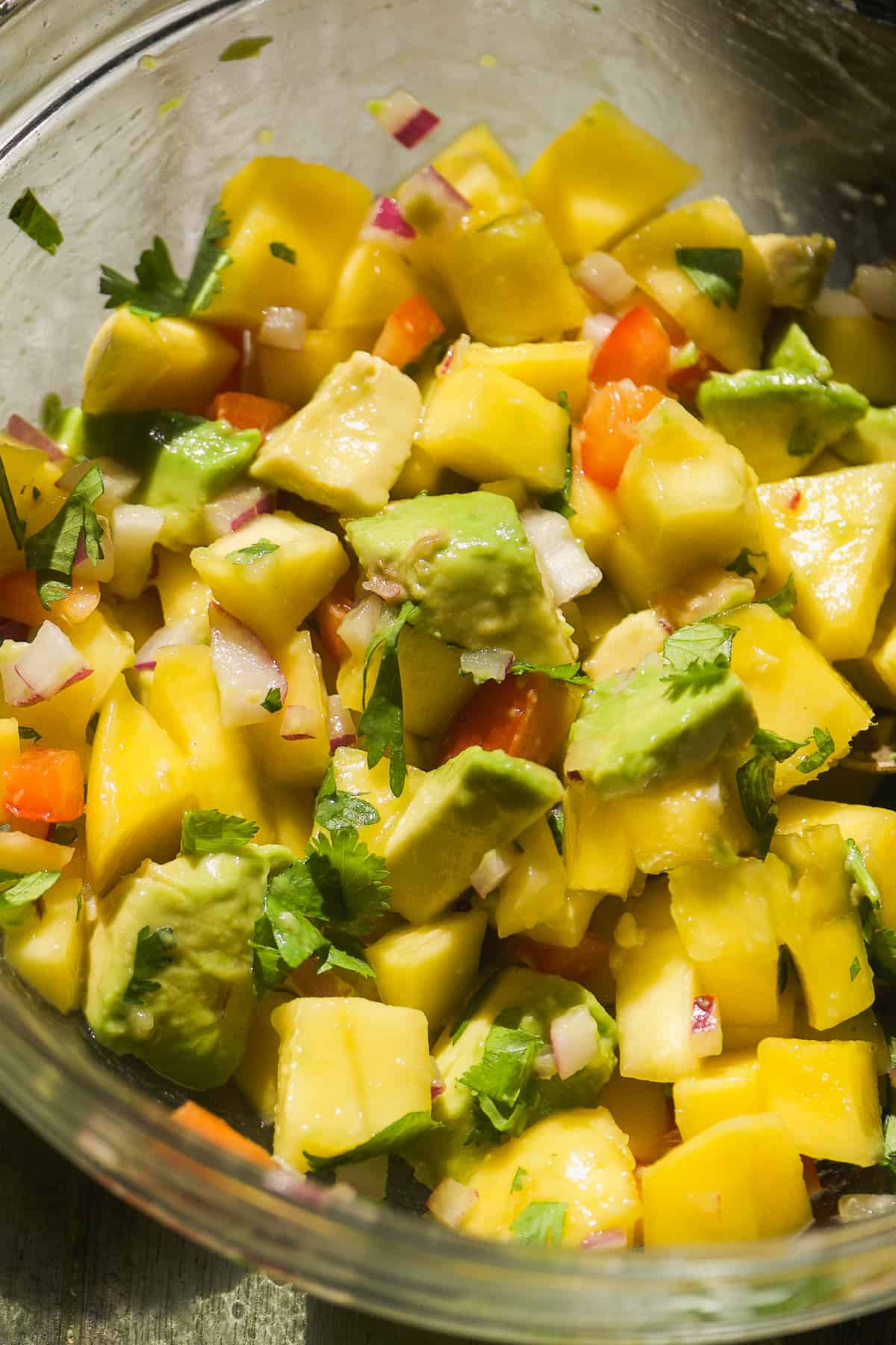 Mango avocado salsa in a glass bowl.