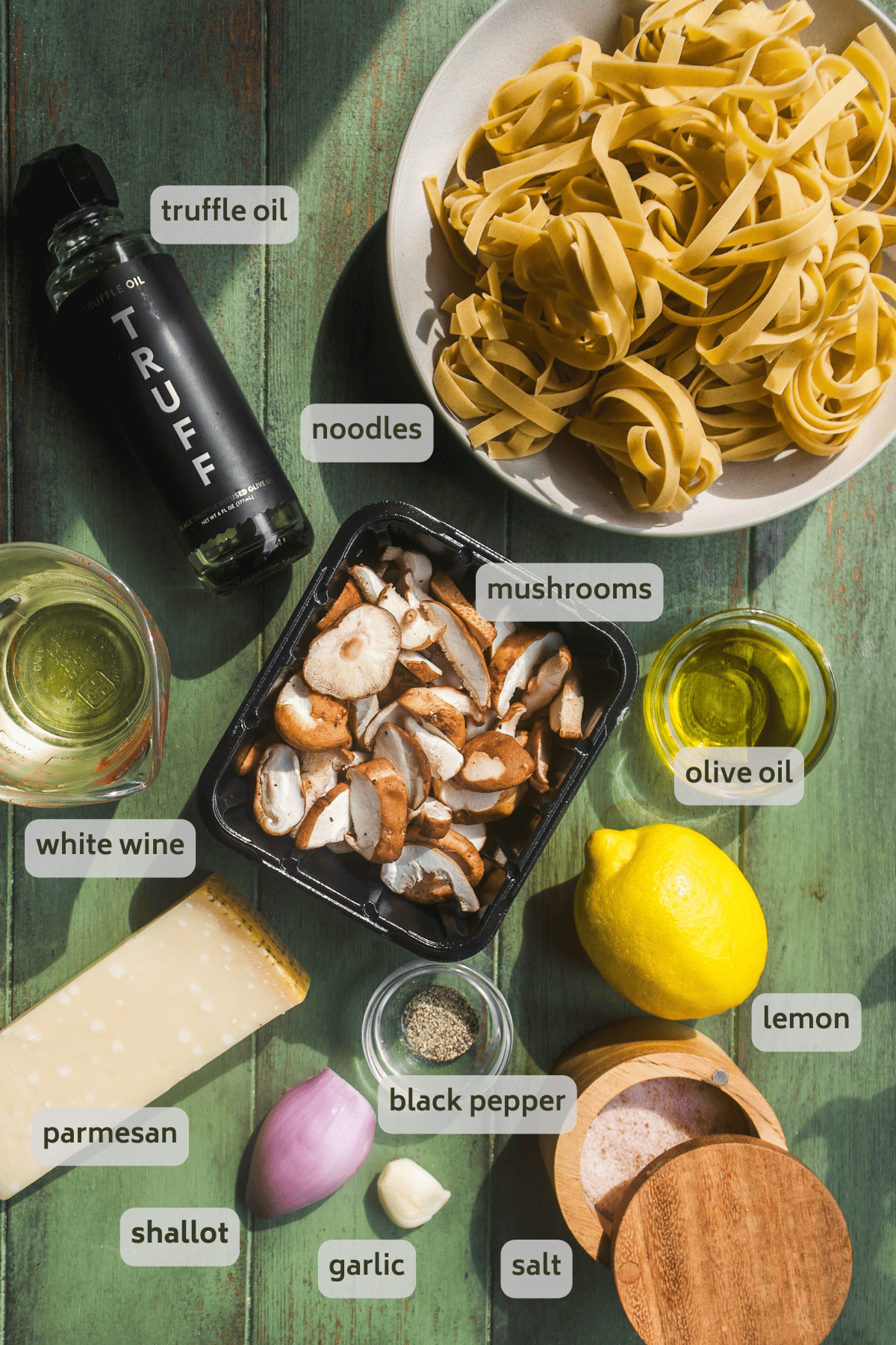 Truffle pasta ingredients on a green surface with labels.