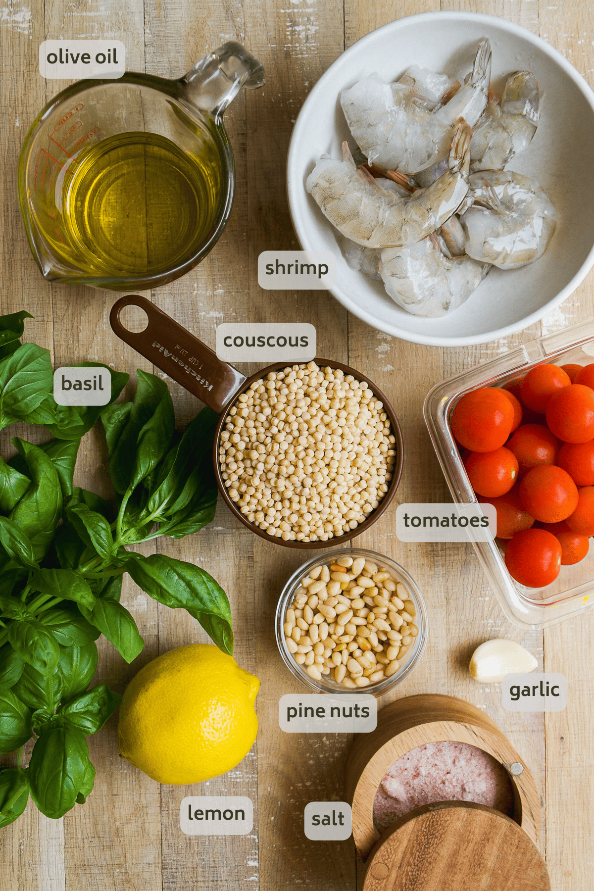 Shrimp bowl ingredients on a wooden surface with labels.