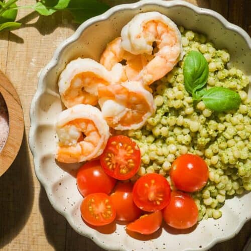 Pesto shrimp bowls with couscous and tomatoes.
