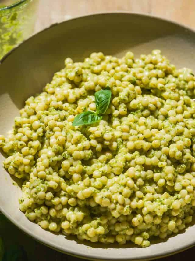 Up close view of a bowl with pesto couscous.