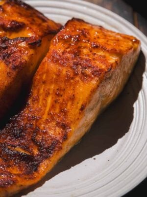 Air fried filets of honey garlic salmon on a plate.