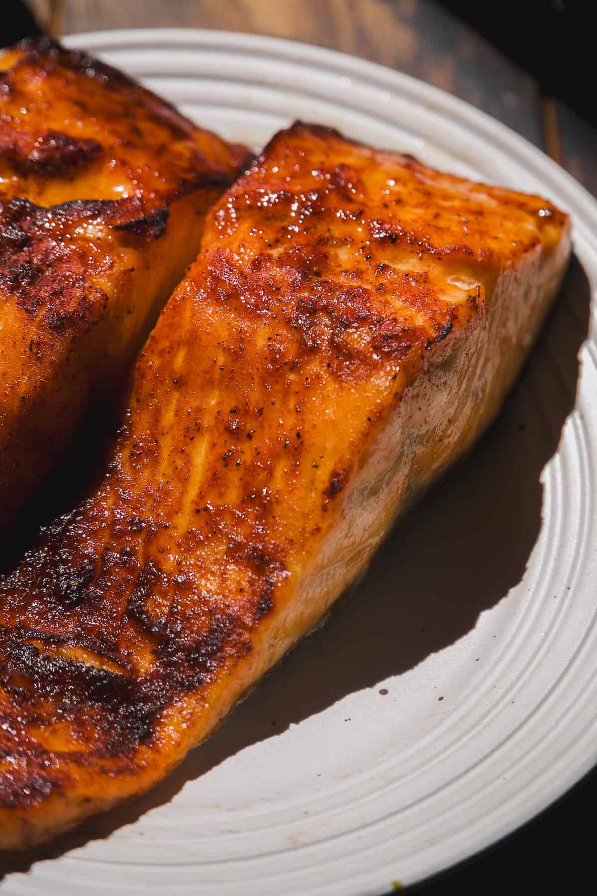 Air fried filets of honey garlic salmon on a plate.