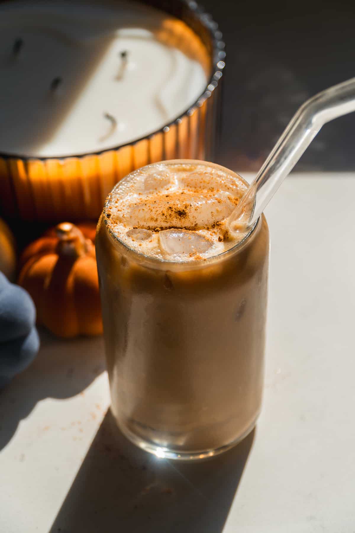 Pumpkin cream cold brew in a glass jar with a straw.