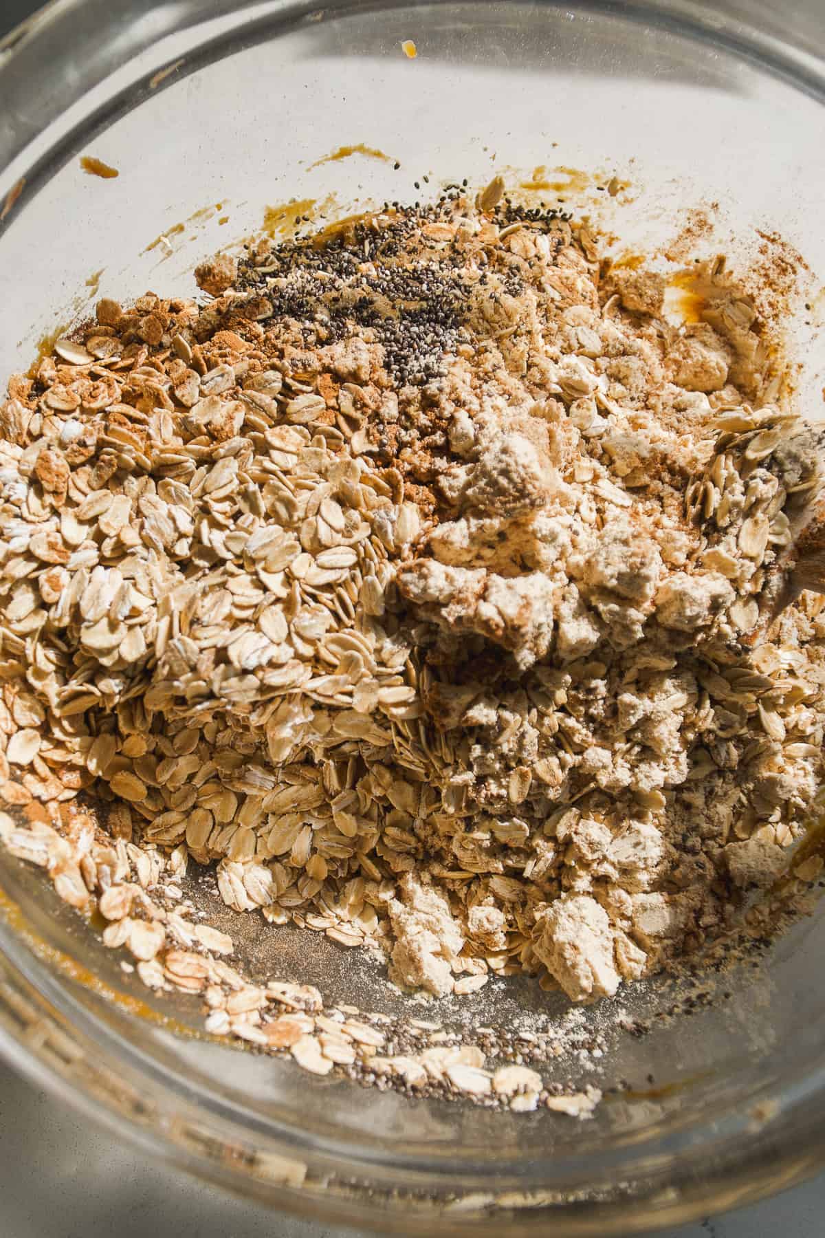 Pumpkin protein ball ingredients about to be mixed in a large bowl.