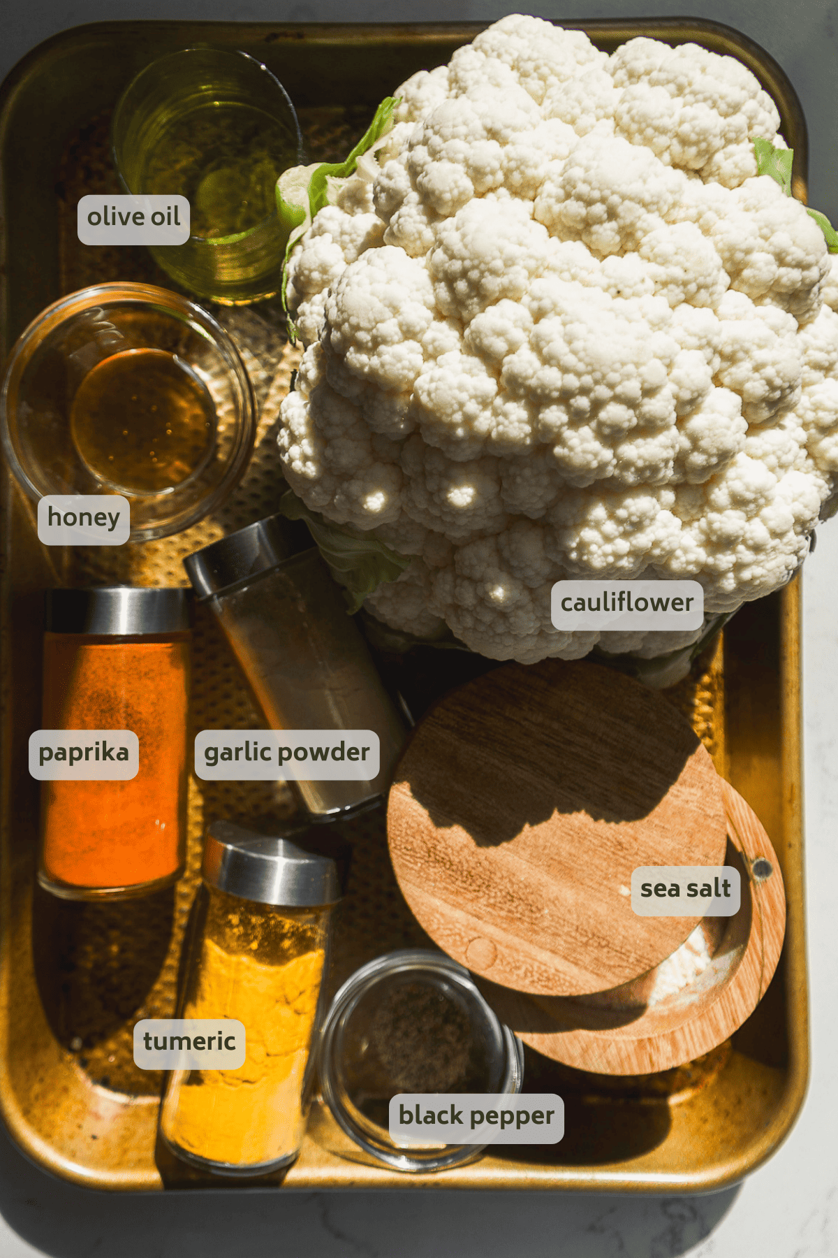 Air fryer cauliflower ingredients on a gold platter.