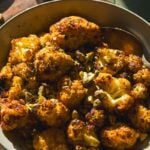 Crispy roasted air fryer cauliflower florets in a bowl.