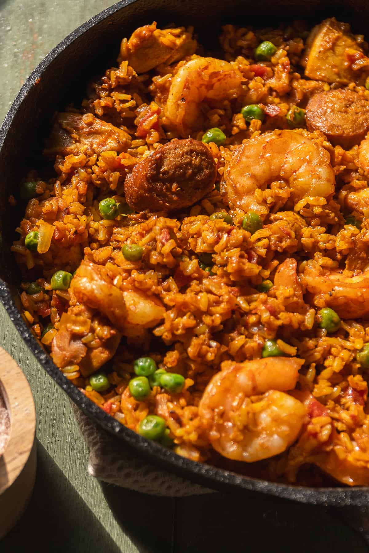 Chorizo and shrimp brown rice paella in a cast iron skillet.