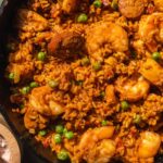 Overhead view of a cast iron with shrimp and chorizo paella.