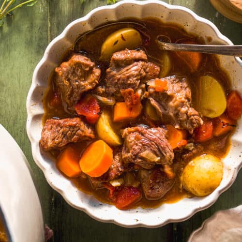 Bowl of beef stew with chuck, potatoes, and carrots.