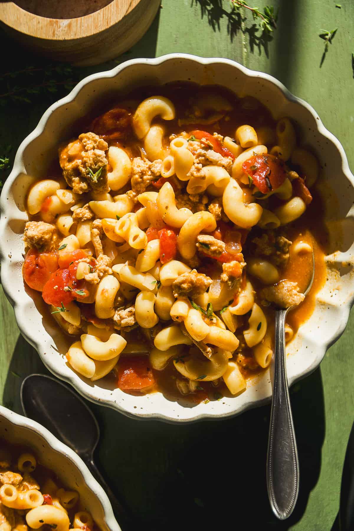 Macaroni soup with tomatoes and ground turkey in a bowl.